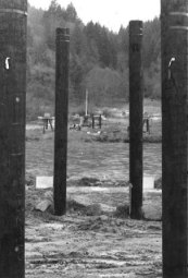 May 1-2: The Army Reserve began to raise the 54-foot high bridge towers. Here we see the bridge site seen through approach piers.